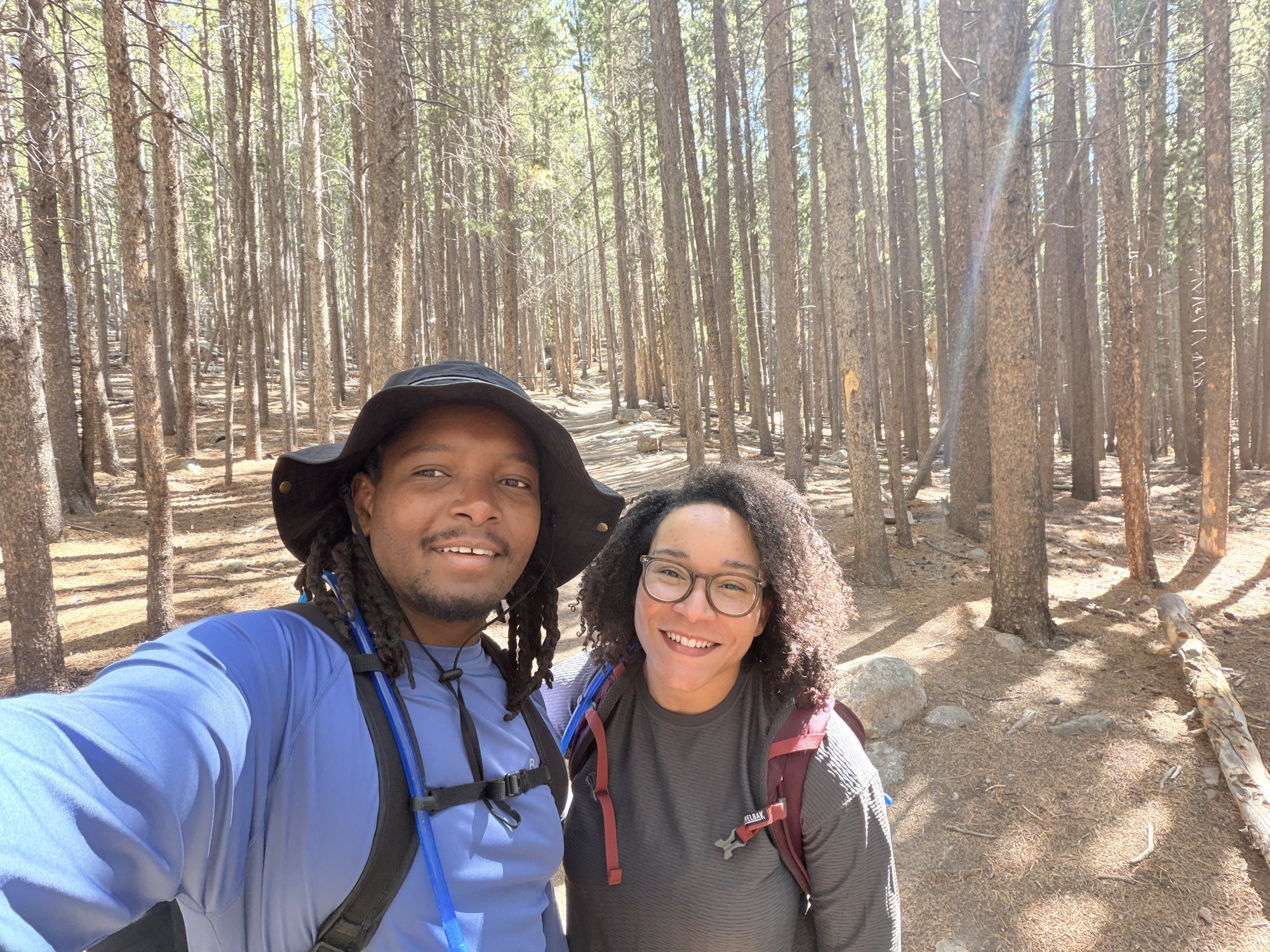 Thomas and Magen hiking in a forest